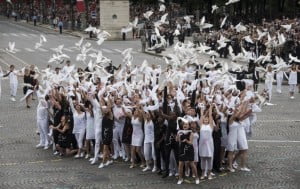 Young people from all invited countries release doves as a symbol of peace in a performance marking the 100th anniversary of the start of World War I during France's Bastille Day celebrations.