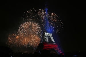 The Eiffel Tower is illuminated during the traditional Bastille Day fireworks display in Paris.