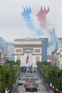 Nine alphajets from the French Air Force Patrouille de France release trails of blue, white and red smoke, the colors of French national flag, as they fly over the Champs-Elysees.
