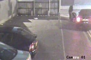 Tony McCluskie dragging a large bag into the boot of a taxi