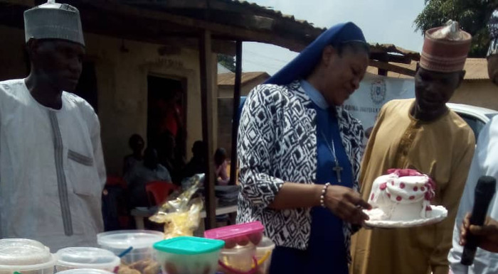 Rev. Sis Agatha Chikelue, Executive Director, Cardinal Onaiyekan Foundation for Peace (COFP), inspecting some of the things made by the women