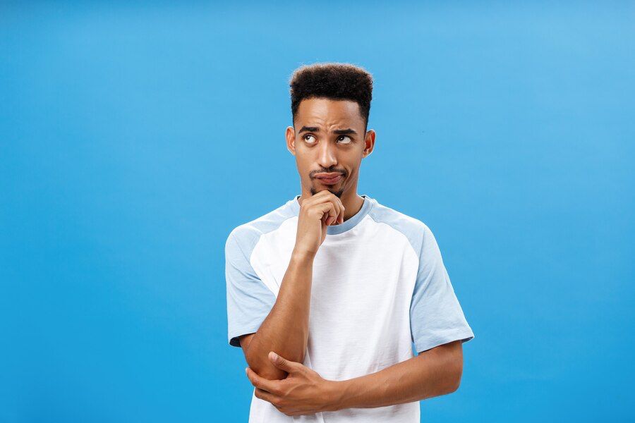 A man with his hand on his chin thinking